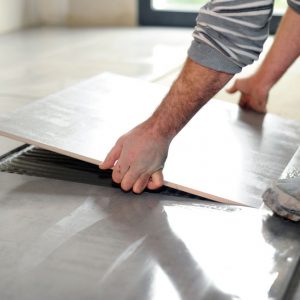 Man laying floor tiles